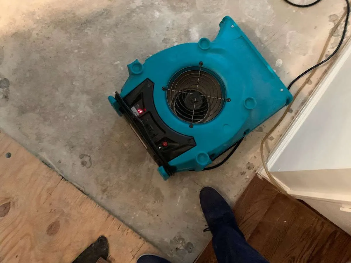 Air mover drying subfloor during Leak Detection & Repair in Edmond